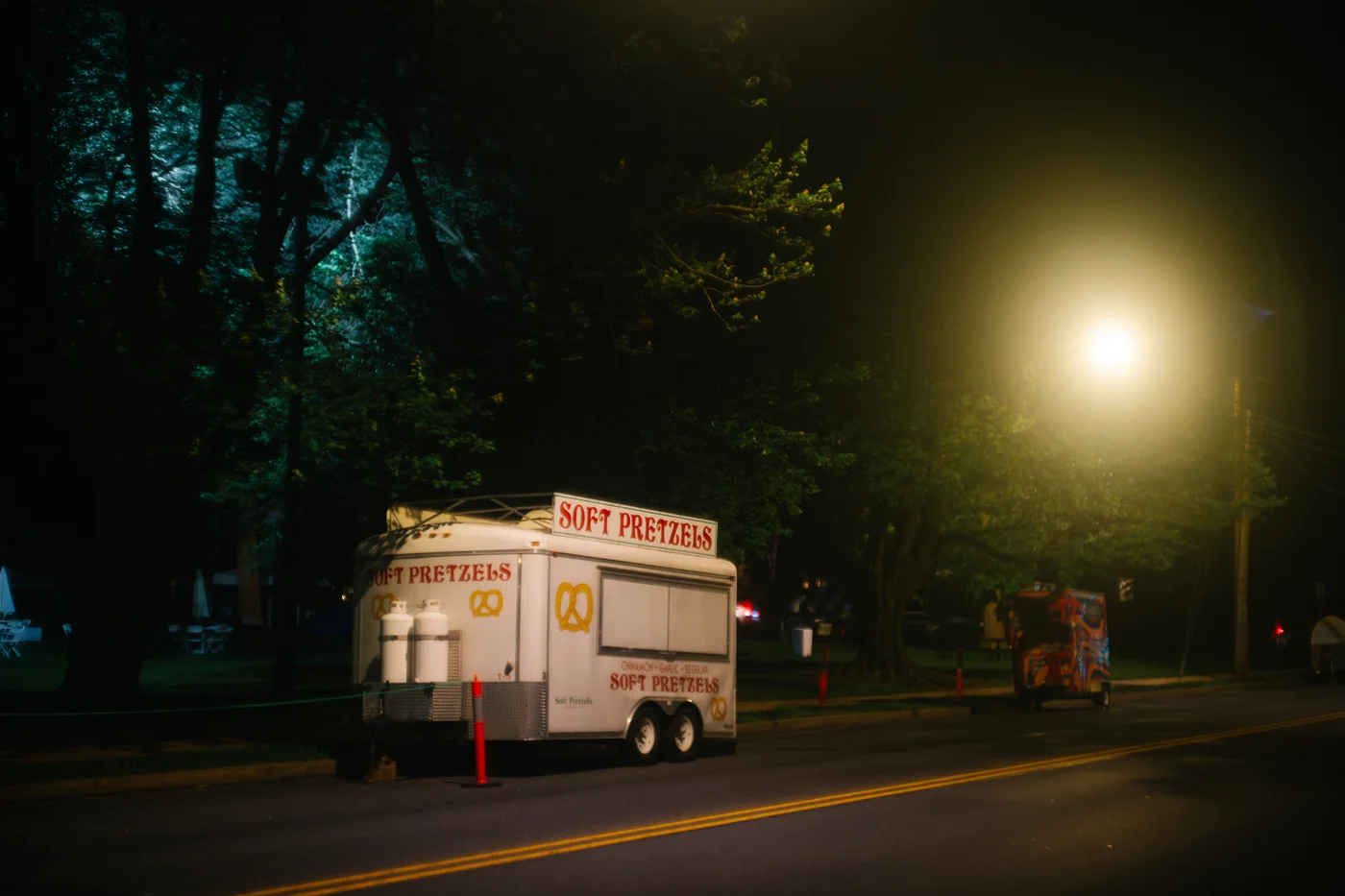 pretzel trailer lit up by streetlights at night.